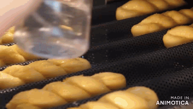 a bunch of bread is being made in a bakery
