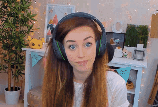 a woman wearing headphones in front of a sign that says c.