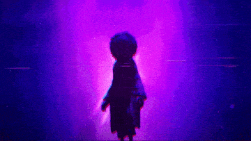 a person standing in a dark room with purple lights