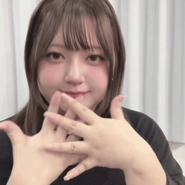 a girl with a ring on her finger is holding her hands together