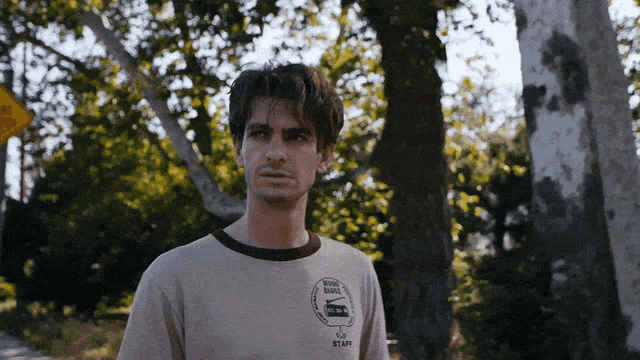 a man wearing a shirt that says staff