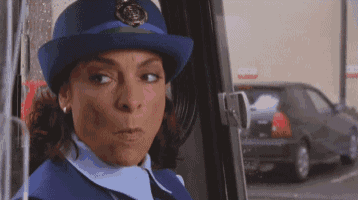 a woman in a blue hat is looking out the window