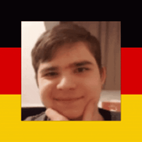 a close up of a young man 's face in front of a german flag .