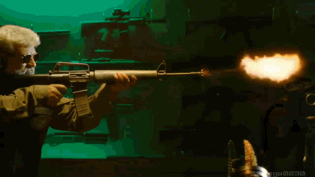 a man holding a gun with a flame coming out of the barrel