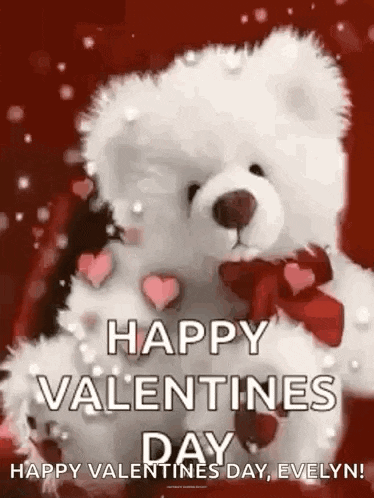 a teddy bear with a red bow on its neck is holding a red heart .