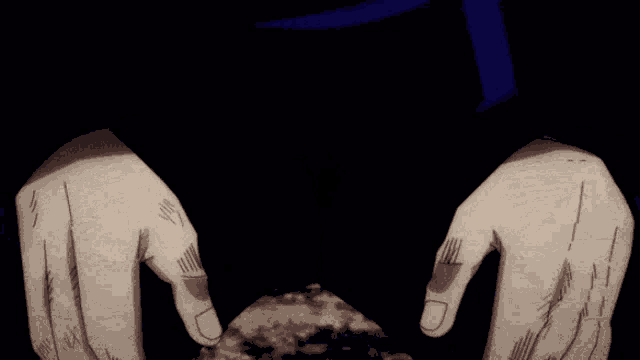 a close up of a person 's hands making a heart shape with their fingers