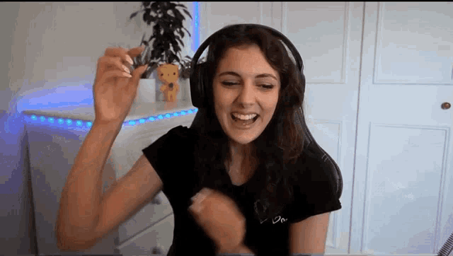 a woman wearing headphones and a t-shirt that says ' i 'm ' on it