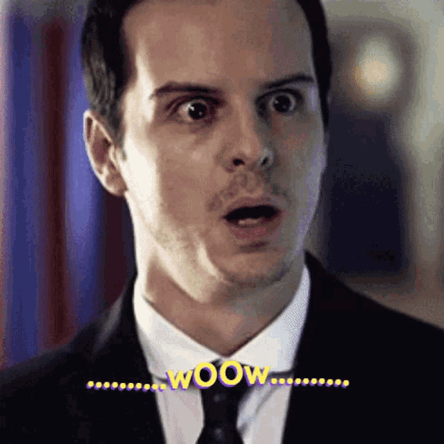 a man in a suit and tie is saying wow with his mouth open