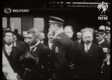 a group of men are standing in front of a sign that says ' reuters ' on it