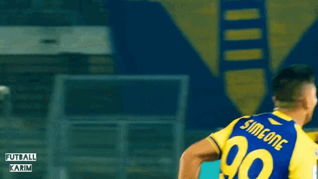 a blurred image of two soccer players with the words futball karim in the corner