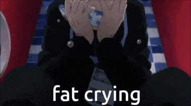 a man is laying on a bed with his hands over his face and crying .
