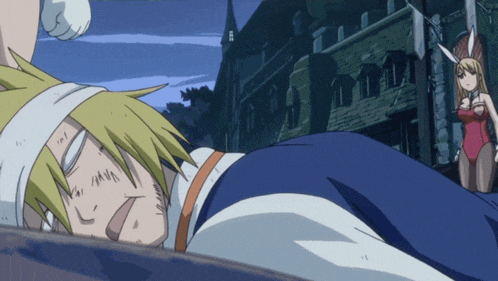 a man is laying on the ground with a woman in a bunny outfit standing behind him