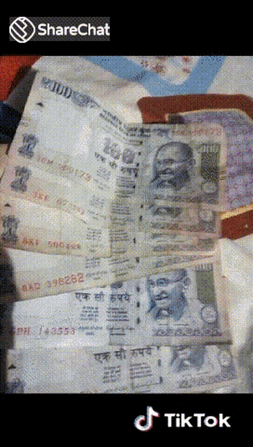 a stack of indian currency is displayed on a table