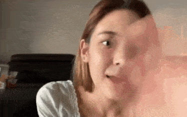 a close up of a woman 's face while looking at something in a mirror .