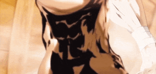 a close up of a person 's torso with a shadow of a cat on it .