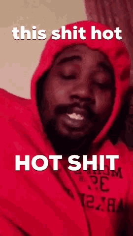 a man wearing a red hoodie with the words this shit hot hot shit