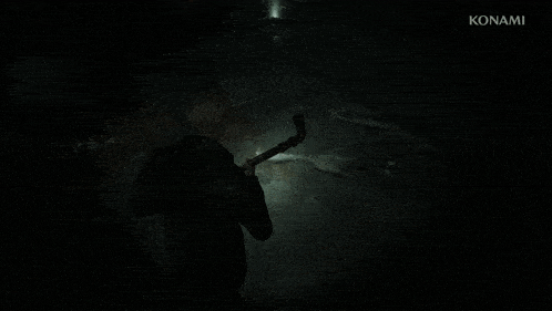 a man holding a flashlight in a dark room with konami written in the corner