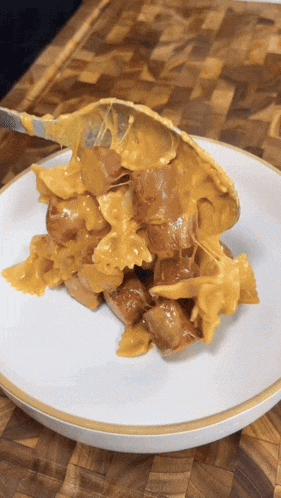 a white plate topped with a piece of food with a spoon in it