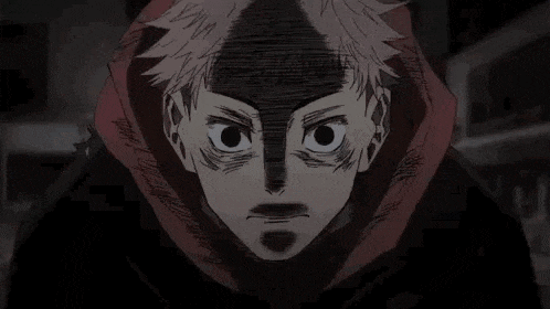 a close up of a person 's face with a shadow on it and a hoodie on .