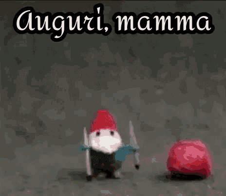 a gnome with skis and a red hat is standing next to a red ball with the words auguri mamma above it