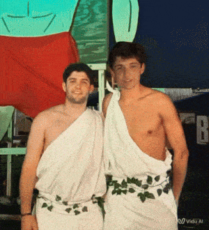 two shirtless men are posing for a picture in front of a sign that says " fb "