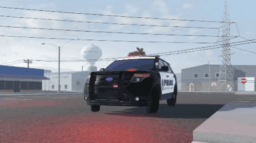a black and white police car is parked on a street