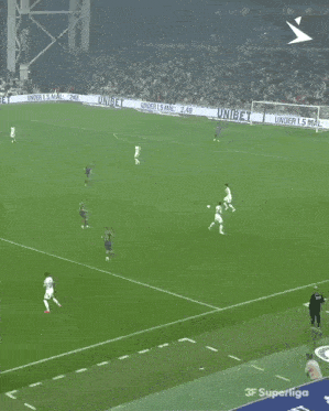 a soccer game is being played on a field with a few players playing