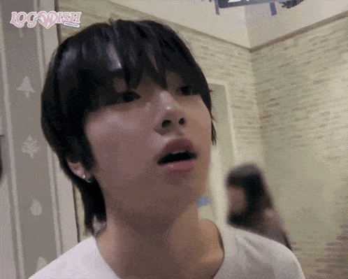 a girl with short hair is wearing a white t-shirt that says log dash