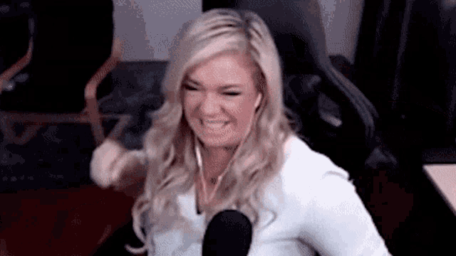 a woman is sitting in a chair in front of a microphone .