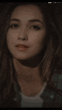 a woman with a red rose in front of her face and a light coming out of her hair