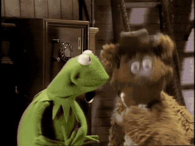 kermit the frog and fozzie bear looking at each other