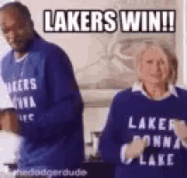 a man and a woman are standing next to each other in a living room .