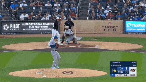 a baseball game is being played in a stadium with advertisements for pilot series and target field