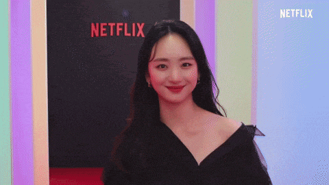 a woman standing in front of a netflix sign