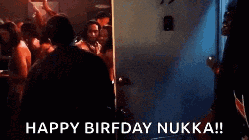 a man in a suit is standing in front of a crowd of people and says happy birfday nukka