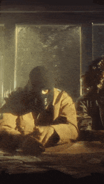 a man in a ski mask is sitting at a table with a bunch of money