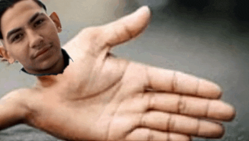 a shirtless man is reaching out his hand to shake someone 's hand