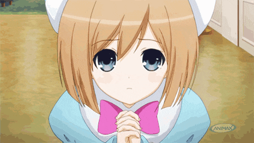 a girl with brown hair and blue eyes is praying with an animax logo in the background