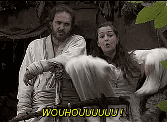 a man and a woman are standing next to each other and the woman says woohoo !
