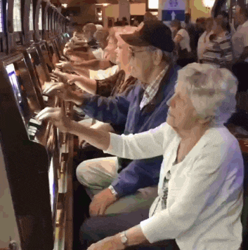 a man and woman are playing a slot machine