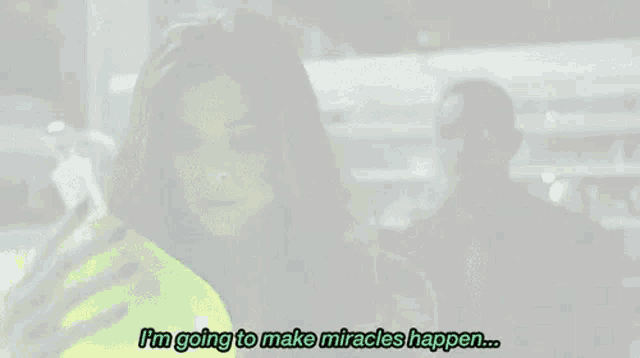 a woman with green hair is holding a green bottle and says `` i 'm going to make miracles happen '' .