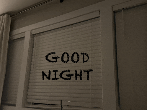 a window with blinds and the words good night on it