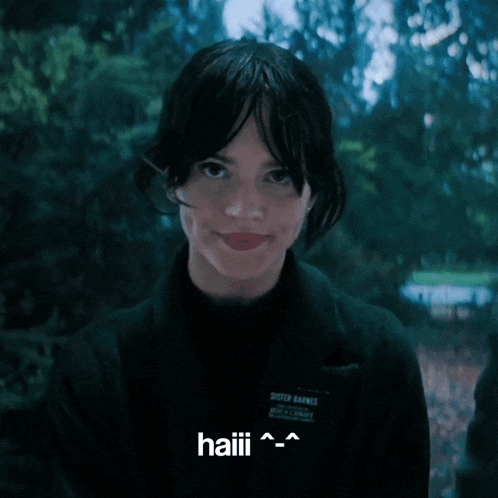 a woman wearing a black shirt that says sister barnes is smiling