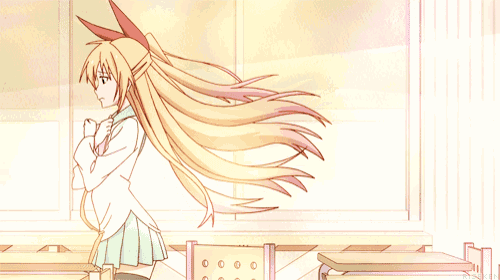 a girl with long blonde hair is standing in front of a window with her hair blowing in the wind