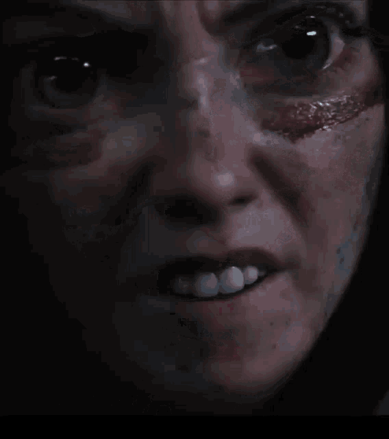 a close up of a person 's face with a few spots of blood on it