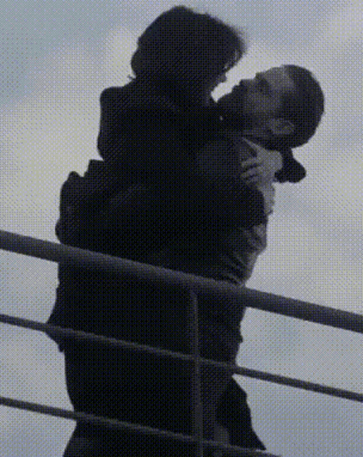 a man is carrying a woman in his arms over a railing ..