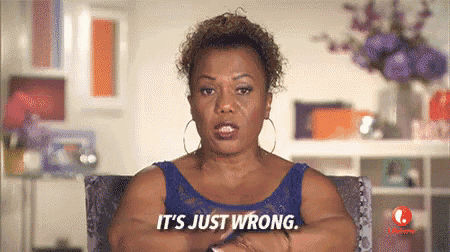a woman in a blue dress is sitting in a chair with her arms crossed and says it 's just wrong .