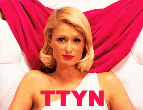 a woman in a white dress with the word ttyn in red