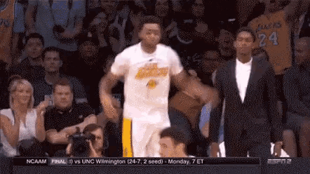 a basketball player wearing a number 24 jersey is dancing in front of a crowd