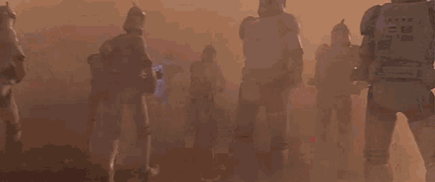 a group of stormtroopers are standing in front of a red smoke cloud .